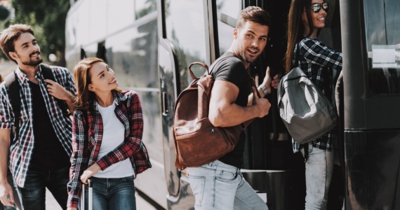 passengers happily boarding a bus